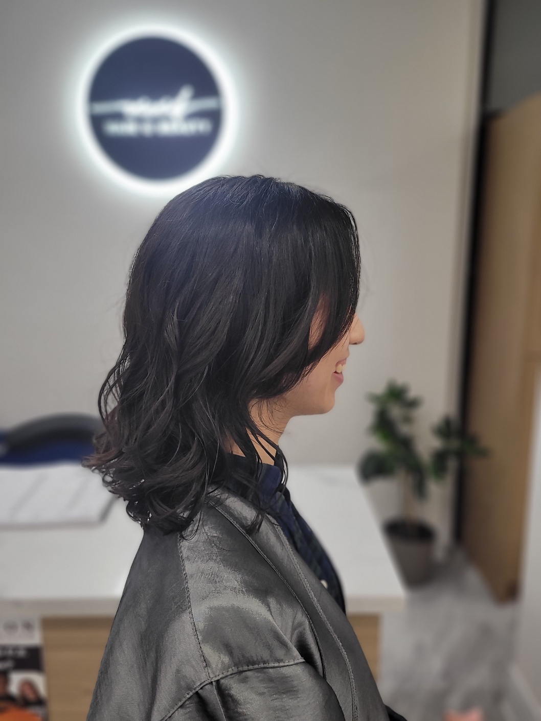 A stylist finishing a cut at Vivid Hair & Beauty